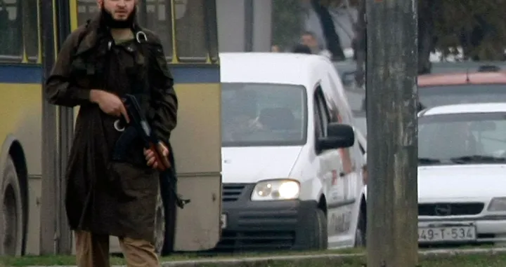 Mevlid Jasarevic (23), stands at an intersection holding an AK-47, after opening fire upon the United States Embassy in Sarajevo, on October 28, 2011. Police acted swiftly and after attempting an arrest, exchanged fire with Jasarevic. The attacker was wounded by Bosnian police, arrested and taken to hospital. His condition is unknown at the moment. AFP PHOTO ELVIS BARUKCIC/Elvis Barukcic