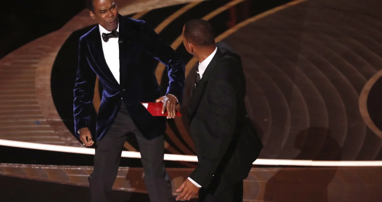 epaselect epa09854780 US actor Will Smith (R) swings at US actor Chris Rock during the 94th annual Academy Awards ceremony at the Dolby Theatre in Hollywood, Los Angeles, California, USA, 27 March 2022. The Oscars are presented for outstanding individual or collective efforts in filmmaking in 24 categories. EPA/ETIENNE LAURENT/Etienne Laurent