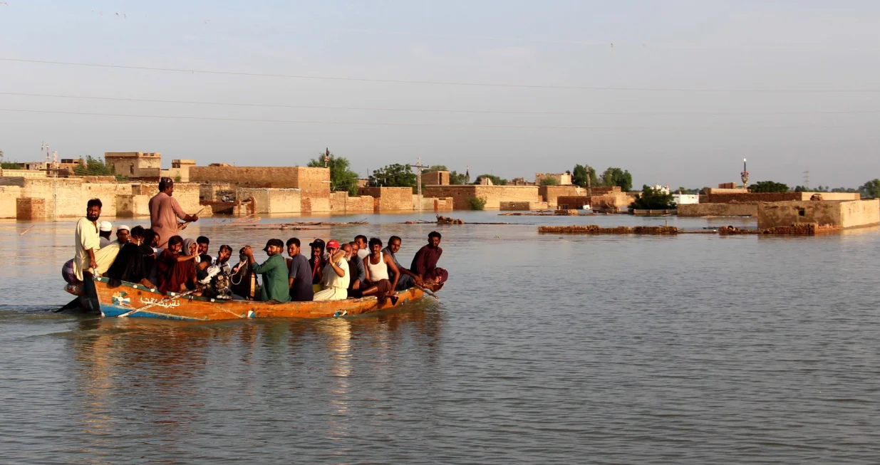 epa10152864 People effected by floods move to higher grounds in Dadu district, Sindh province, Pakistan, 01 September 2022. According to the National Disaster Management Authority (NDMA) on 27 August, flash floods triggered by heavy monsoon rains have killed over 1,000 people across Pakistan since mid-June 2022. More than 33 million people have been affected by floods, the country's climate change minister said. EPA/WAQAR HUSSEIN/Waqar Hussein
