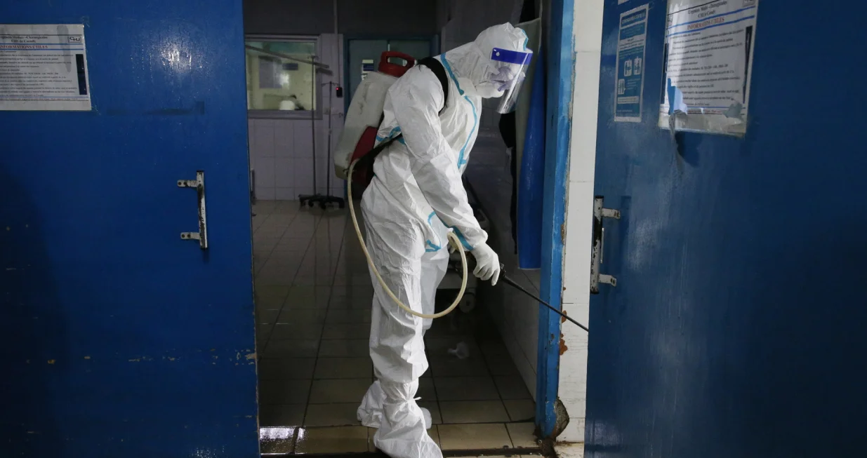 epa09417004 An agent of the National Institute of Public Hygiene (INHP) wearing personal protective equipment (PPE) suit disinfects the premises of the CHU hospital of Cocody after a case of the Ebola virus was confirmed, in Abidjan, Cote d'Ivoire, 16 August 2021. Ivorian ministry of health confirmed on 14 August a patient tested positive with the Ebola virus after travelling to Abidjan from the neighboring Guinea, the first Ebola case reported in the Ivory Coast in 25 years. Health authorities began disinfecting the premises of the Cocody hospital, where the patient was first admitted, and vaccinating health workers against Ebola. EPA/LEGNAN KOULA/Legnan Koula
