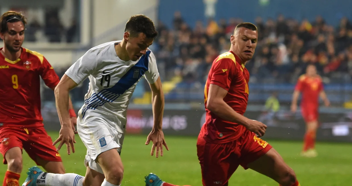 epa09856512 Greece's Anastasios Douvikas (L) in action against Montenegro's Milutin Osmajic (R) during the international friendly soccer match between Montenegro and Greece in Podgorica, Montenegro, 28 March 2022. EPA/BORIS PEJOVIC
