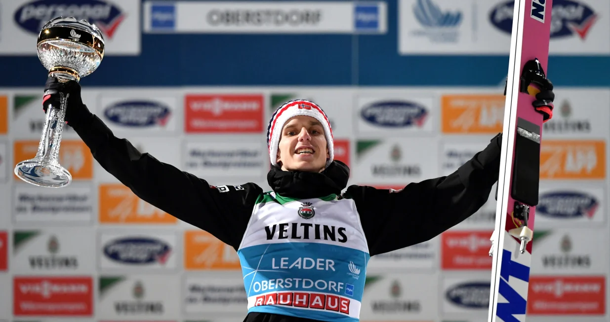 epa10381709 Halvor Egner Granerud of Norway celebrates on the podium after winning the first stage of the 71st Four Hills Ski Jumping Tournament in Oberstdorf, Germany, 29 December 2022. EPA/Anna Szilagyi