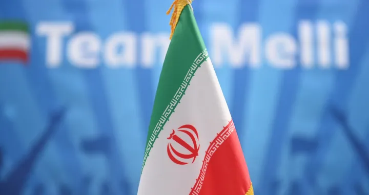 epa10319954 The flag of Iran in front of a Team Melli banner during a training session of the Iranian team in Doha, Qatar, 22 November 2022. Iran lost their first match of the FIFA World Cup 2022 against England on 21 November and will face Wales in their next fixture. Team Melli means national team and is the nickname of the Irananian national team. EPA/NEIL HALL