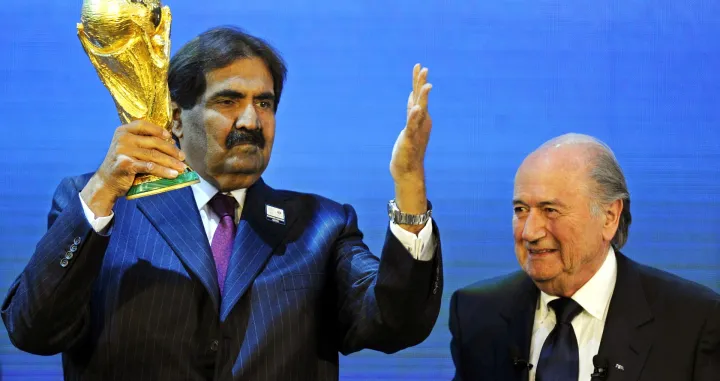 epa10253873 Photo taken on 02 December 2010 of then FIFA president Joseph Blatter (R) and Sheikh Hamad bin Khalifa Al-Thani (L), Emir of Qatar, with the World Cup trophy after Qatar was announced to host the FIFA soccer World Cup 2022 during the FIFA 2018 and 2022 World Cup Bid Announcement in Zurich, Switzerland. The FIFA World Cup 2022 will take place from 20 November to 18 December 2022 in Qatar. EPA/WALTER BIERI *** Local Caption *** 53610242