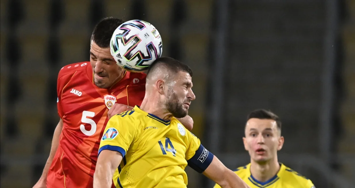 epa08730258 Valon Berisha of Kosovo (R) in action against Arijan Ademi of North Macedonia (L) during the Euro Qualification Semi-final play-off match between North Macedonia and Kosovo in Skopje, North Macedonia, 08 October 2020. EPA/GEORGI LICOVSKI