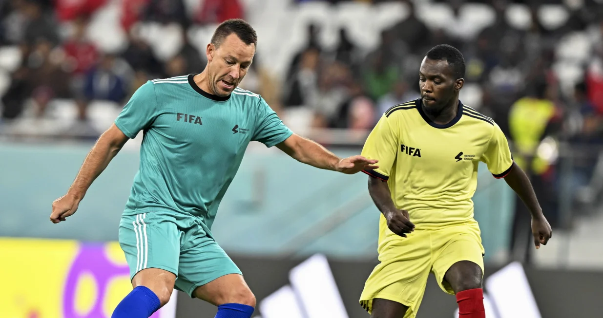 epa10362451 Former English player John Terry (L) in action during the Workers and FIFA Legends soccer match at Al Thumama Stadium in Doha, Qatar, 12 December 2022. FIFA World Cup 2022 guests and volunteers watched workers and FIFA legends playing in a 60-minute match. EPA/NOUSHAD THEKKAYIL
