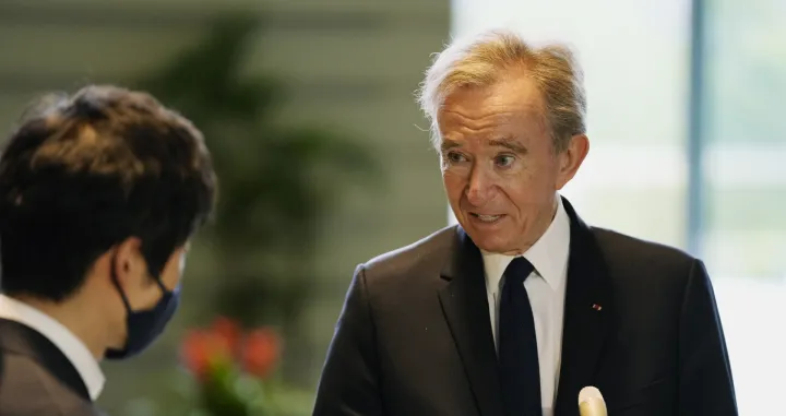 epa09922193 LVMH Moet Hennessy Louis Vuitton CEO Bernard Arnault (R) speaks to the press following his meeting with Japanese Chief Cabinet Secretary Hirokazu Matsuno (not pictured) at the Prime Minister's Office in Tokyo, Japan, 02 May 2022. EPA/Hiro Komae/POOL/Hiro Komae/Pool
