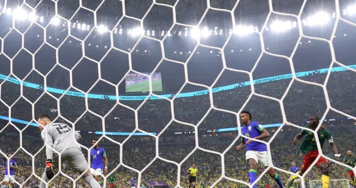 epa10345405 Vincent Aboubakar of Cameroon (R) scores the 1-0 goal against goalkeeper Ederson of Brazil (L) during the FIFA World Cup 2022 group G soccer match between Cameroon and Brazil at Lusail Stadium in Lusail, Qatar, 02 December 2022. EPA/Ali Haider