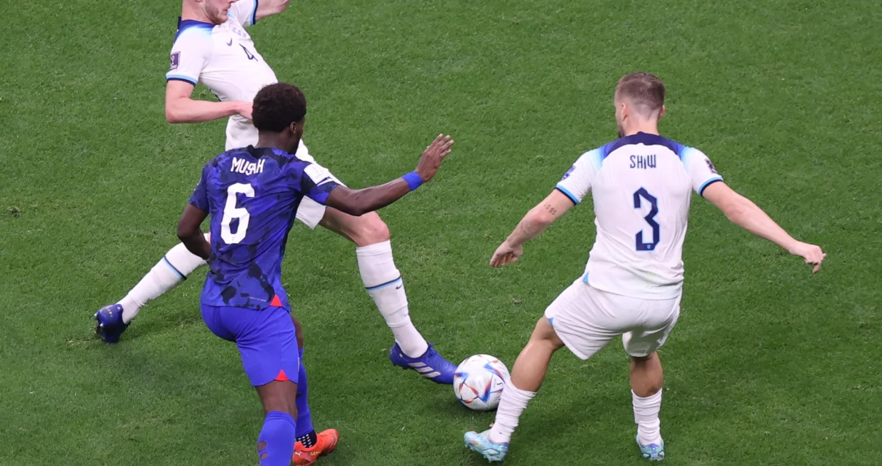 epa10328801 Yunus Musah of the US (C) in action against Luke Shaw of England (R) and Declan Rice of England during the FIFA World Cup 2022 group B soccer match between England and the USA at Al Bayt Stadium in Al Khor, Qatar, 25 November 2022. EPA/Mohamed Messara