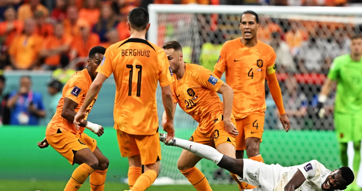 epa10336742 Mohammed Muntari of Qatar (on the ground) in action against Teun Koopmeiners of the Netherlands during the FIFA World Cup 2022 group A soccer match between the Netherlands and Qatar at Al Bayt Stadium in Al Khor, Qatar, 29 November 2022. EPA/Noushad Thekkayil