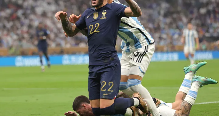 epa10372251 Theo Hernandez (front) of France in action against Cristian Romero of Argentina during the FIFA World Cup 2022 Final between Argentina and France at Lusail stadium, Lusail, Qatar, 18 December 2022. EPA/Friedemann Vogel