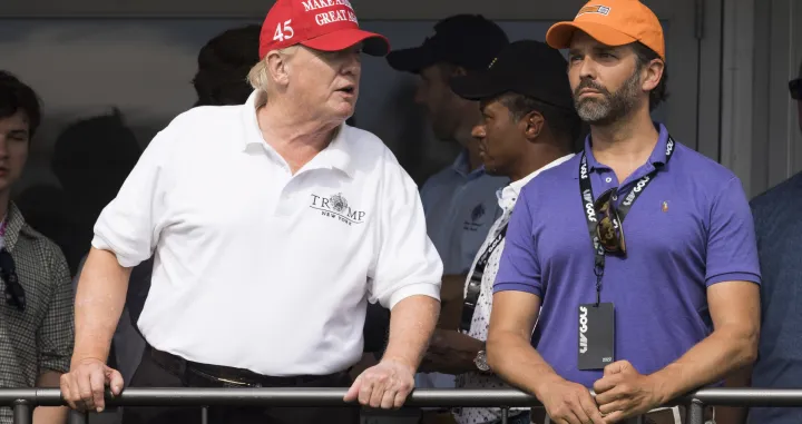 epa10100977 Former US President Donald J. Trump (L) and his son Donald Trump Jr. (R) watch the third round of the LIV Golf Bedminster invitational, part of the new LIV Golf Invitational Series, at the Trump National Golf Club in Bedminster, New Jersey, USA, 31 July 2022. EPA/JUSTIN LANE/Justin Lane