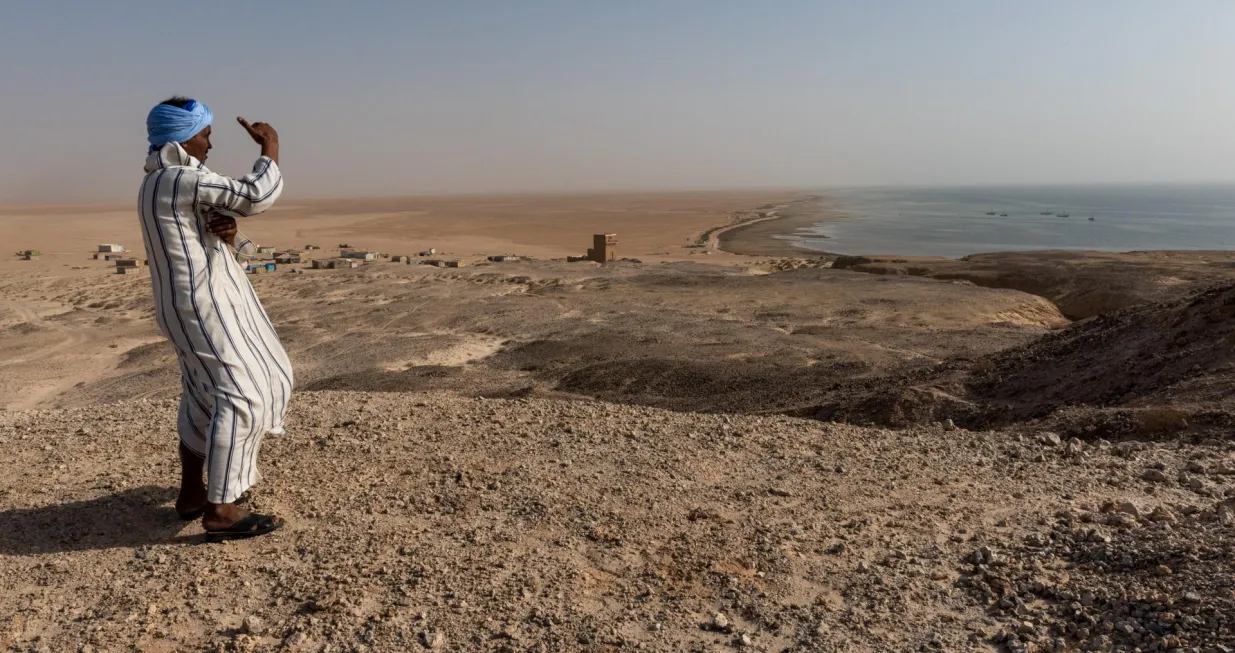 14 January 2019, Banc D'Arguin, National Park Nature Reserve, Mauritania. The small fishing village Arkei is seen in the distance. Mr. Iveko Mohammed, has always had a passion for the environment and the Banc d'Arguin where he grew up. He has now been working as the deputy head of surveillance guards for 12 years, and he knows the park as his own backyard...THE PROJECTThe Biodiversity and Hydrocarbon Project aimed at integrating marine and coastal biodiversity in the policies and practices of the offshore oil and gas industry so that it does not degrade marine and coastal natural resources and ecosystems. Mauritania's marine and coastal environments support significant biological diversity. The Banc d'Arguin National Park is a UNESCO World Heritage site. Banc d'Arguin is a nesting and breeding area for birds; each winter, it is home to the largest concentration of Palearctic migratory birds, and is a habitat for a large number of marine animals...https://open.undp.org/projects/00059643/Hp