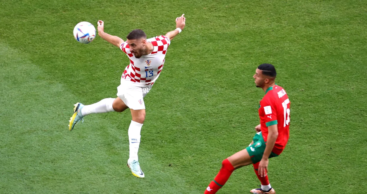 epa10321960 Selim Amallah (R) of Morocco in action against Nikola Vlasic of Croatia during the FIFA World Cup 2022 group F soccer match between Morocco and Croatia at Al Bayt Stadium in Al Khor, Qatar, 23 November 2022. EPA/Abedin Taherkenareh