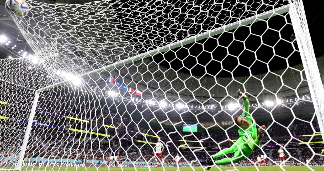 epa10348272 Goalkeeper Wojciech Szczesny of Poland is beaten as France score their second goal during the FIFA World Cup 2022 round of 16 soccer match between France and Poland at Al Thumama Stadium in Doha, Qatar, 04 December 2022. EPA/Friedemann Vogel