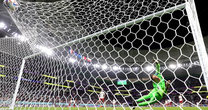 epa10348272 Goalkeeper Wojciech Szczesny of Poland is beaten as France score their second goal during the FIFA World Cup 2022 round of 16 soccer match between France and Poland at Al Thumama Stadium in Doha, Qatar, 04 December 2022. EPA/Friedemann Vogel