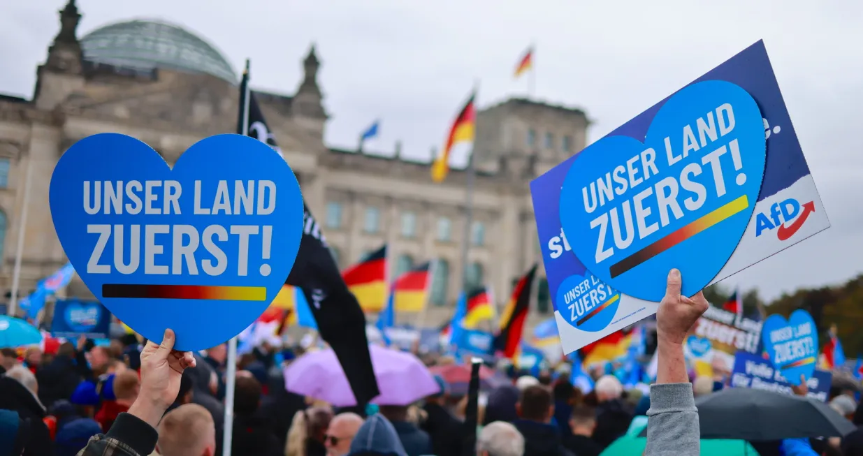 epa10230592 Protesters hold placards reading 'Our country first!' as they demonstrate in front of Reichstags building in Berlin, Germany, 08 October 2022. The right-wing populist Alternative for Germany (Alternative fuer Deutschland, AfD) party called for a demonstration against rising prices. EPA/HANNIBAL HANSCHKE/Hannibal Hanschke