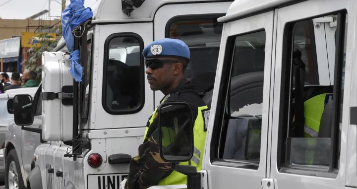 epa10367207 A UN peacekeeper stands stands at the site where a convoy of UN peacekeeping force UNIFIL came under attack in Al-Aqbieh, in south Lebanon, 15 December 2022. The Irish Defense Forces confirmed the death of one of its peacekeepers in a 'serious incident' in Lebanon on the night of 14 December when a convoy of two Armoured Utility Vehicles (AUVs) carrying eight personnel travelling to Beirut came under small arms fire. The UNIFIL said a peacekeeper was killed and three others were injured in the incident, adding that the peacekeepers force is 'coordinating with the Lebanese Armed Forces and launched an investigation to determine exactly what happened'. EPA/ABBAS SALMAN/Abbas Salman