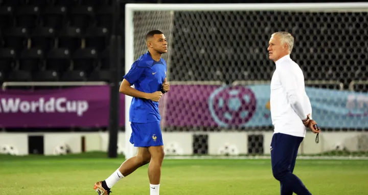 epa10363529 France's head coach Didier Deschamps (R) and Kylian Mbappe (L) attend their team's training session in Doha, Qatar, 13 December 2022. France will face Morocco in their FIFA World Cup 2022 semi final soccer match on 14 December 2022. EPA/MARTIN DIVISEK