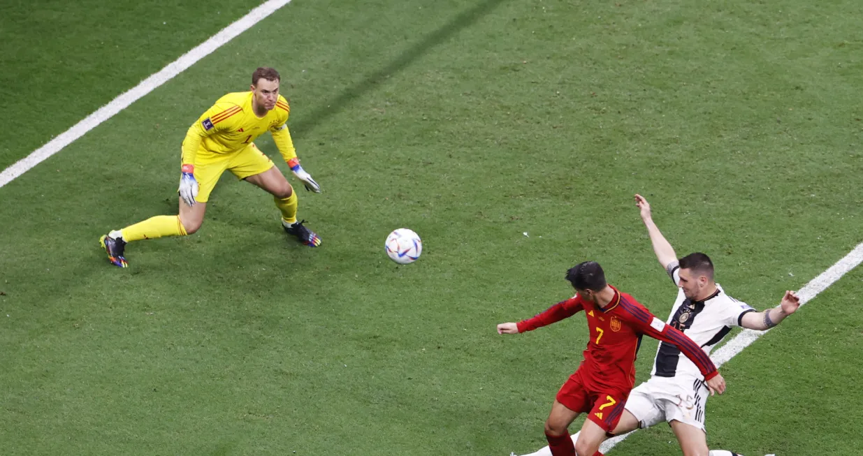 epa10333363 Alvaro Morata of Spain (2-R) scores the 1-0 goal against goalkeeper Manuel Neuer of Germany during the FIFA World Cup 2022 group E soccer match between Spain and Germany at Al Bayt Stadium in Al Khor, Qatar, 27 November 2022. EPA/Rungroj Yongrit