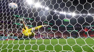 epa10352414 Hakim Ziyech of Morocco converts against goalkeeper Unai Simon of Spain during the penalty shoot-out of the FIFA World Cup 2022 round of 16 soccer match between Morocco and Spain at Education City Stadium in Doha, Qatar, 06 December 2022. EPA/TOLGA BOZOGLU