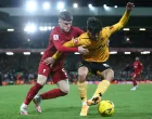 epa10394856 Ben Doak of Liverpool in action against Hugo Bueno of Wolverhampton Wanderers during the 3rd round FA Cup soccer match between Liverpool and Wolverhampton Wanderers at Anfield in Liverpool, Britain, 07 January 2023. EPA/ADAM VAUGHAN