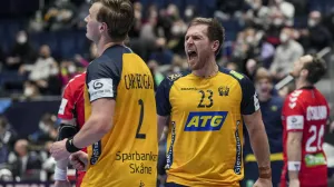 epa09709221 Jonathan Carlsbogard (L) and Albin Lagergren (R) of Sweden celebrate winning the Men's European Handball Championship main round match between Sweden and Norway in Bratislava, Slovakia, 25 January 2022. EPA/MARTIN DIVISEK