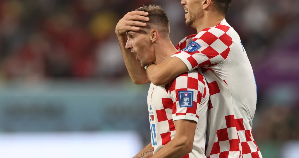 epa10370272 Mislav Orsic of Croatia celebrates with teammate Ivan Perisic (R) after scoring the 2-1 lead during the FIFA World Cup 2022 third place soccer match between Croatia and Morocco at Khalifa International Stadium in Doha, Qatar, 17 December 2022. EPA/Tolga Bozoglu