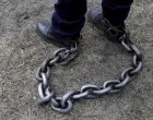 epaselect epa09723002 A Romanian policeman has his legs tied with a heavy chain during a rally held in front of the Romanian Parliament headquarters in Bucharest, Romania, 02 February 2022. About 1,500 policemen, prison guards and retired defense system employees from all over the country, gathered by fourteen trade union organizations, including Europol, joined a protest demanding the government to comply with the law on the remuneration of staff paid from public funds. Protesters marched through the center of Romania's capital asking for their risk supplementary payment and full pensions, demanding better working conditions and the employment of additional staff for solving specific tasks in a timely manner. EPA/ROBERT GHEMENT/Robert Ghement