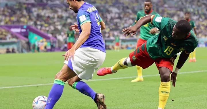 epa10345263 Collins Fai (R) of Cameroon in action against Marquinhos (L) of Brazil during the FIFA World Cup 2022 group G soccer match between Cameroon and Brazil at Lusail Stadium in Lusail, Qatar, 02 December 2022. EPA/Abedin Taherkenareh