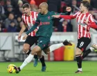 epa10386657 Fabinho of Liverpool (C) in action against Vitaly Janelt (L) and Mathias Jensen (R) of Brentford during the English Premier League soccer match between Brentford FC and Liverpool FC in Brentford, Britain, 02 January 2023. EPA/Kieran Galvin EDITORIAL USE ONLY. No use with unauthorized audio, video, data, fixture lists, club/league logos or 'live' services. Online in-match use limited to 120 images, no video emulation. No use in betting, games or single club/league/player publications