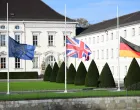 epa08821611 National flags of Great Britain (C), Germany (R), and the European Union are set half mast during a visit of the British royal couple to Bellevue palace in Berlin, Germany, 15 November 2020. The British royal couple are scheduled to attend events 15 November on Germany's National Day of Mourning that commemorates victims of war and fascism, during which Prince Charles is to give a speech at the Bundestag. EPA/CLEMENS BILAN/Clemens Bilan