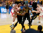 May 2, 2025; San Francisco, California, USA; Golden State Warriors forward Jimmy Butler III (10) forces a jump ball while defending Houston Rockets forward Amen Thompson (1) in the fourth quarter of game six of the first round for the 2025 NBA Playoffs at Chase Center. Mandatory Credit: Cary Edmondson-Imagn Images