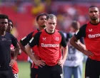 Soccer Football - Bundesliga - Bayer Leverkusen v Borussia Dortmund - BayArena, Leverkusen, Germany - May 11, 2025 Bayer Leverkusen's Florian Wirtz and Jonathan Tah look dejected with teammates after the match REUTERS/Thilo Schmuelgen DFL REGULATIONS PROHIBIT ANY USE OF PHOTOGRAPHS AS IMAGE SEQUENCES AND/OR QUASI-VIDEO.