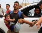 A Palestinian man carries a wounded person to Nasser hospital following an Israeli strike, in Khan Younis, southern Gaza Strip, May 15, 2025. REUTERS/Hatem Khaled/Hatem Khaled