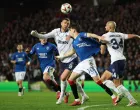 Soccer Football - Europa League - Round of 16 - Second Leg - Rangers v Fenerbahce - Ibrox, Glasgow, Scotland, Britain - March 13, 2025 Fenerbahce's Edin Dzeko in action with Rangers' Ianis Hagi REUTERS/Russell Cheyne