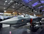 FILE PHOTO: Visitors stand next to a prototype of the Advanced Medium Combat Aircraft (AMCA), India's most advanced stealth fighter jet, at the "Aero India 2025" air show at Yelahanka air base in Bengaluru, India, February 11, 2025. REUTERS/Stringer/File Photo/Stringer
