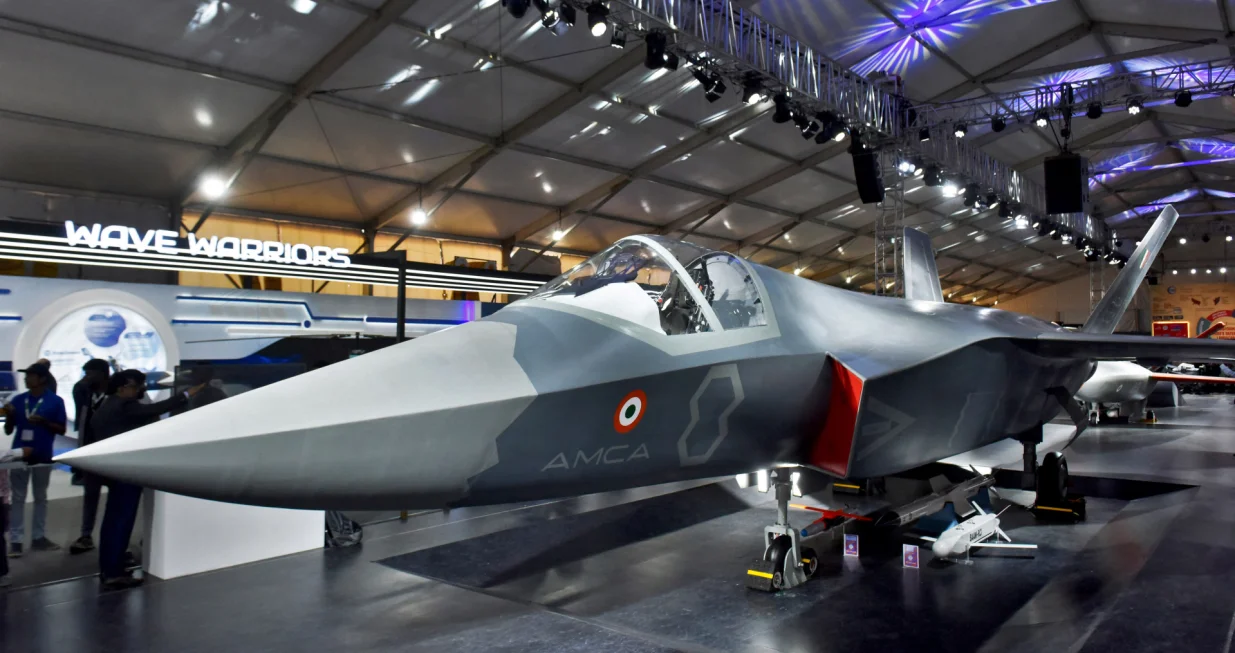 FILE PHOTO: Visitors stand next to a prototype of the Advanced Medium Combat Aircraft (AMCA), India's most advanced stealth fighter jet, at the "Aero India 2025" air show at Yelahanka air base in Bengaluru, India, February 11, 2025. REUTERS/Stringer/File Photo/Stringer