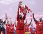 Soccer Football - Premier League - Liverpool v Crystal Palace - Anfield, Liverpool, Britain - May 25, 2025 Liverpool's Joe Gomez celebrates with the trophy after winning the Premier League REUTERS/Phil Noble EDITORIAL USE ONLY. NO USE WITH UNAUTHORIZED AUDIO, VIDEO, DATA, FIXTURE LISTS, CLUB/LEAGUE LOGOS OR 'LIVE' SERVICES. ONLINE IN-MATCH USE LIMITED TO 120 IMAGES, NO VIDEO EMULATION. NO USE IN BETTING, GAMES OR SINGLE CLUB/LEAGUE/PLAYER PUBLICATIONS. PLEASE CONTACT YOUR ACCOUNT REPRESENTATIVE FOR FURTHER DETAILS..
