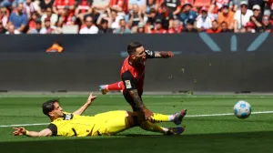 Soccer Football - Bundesliga - Bayer Leverkusen v Borussia Dortmund - BayArena, Leverkusen, Germany - May 11, 2025 Bayer Leverkusen's Alex Grimaldo is fouled by Borussia Dortmund's Ramy Bensebaini, decision of penalty later overturned by VAR REUTERS/Thilo Schmuelgen DFL REGULATIONS PROHIBIT ANY USE OF PHOTOGRAPHS AS IMAGE SEQUENCES AND/OR QUASI-VIDEO.