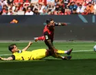 Soccer Football - Bundesliga - Bayer Leverkusen v Borussia Dortmund - BayArena, Leverkusen, Germany - May 11, 2025 Bayer Leverkusen's Alex Grimaldo is fouled by Borussia Dortmund's Ramy Bensebaini, decision of penalty later overturned by VAR REUTERS/Thilo Schmuelgen DFL REGULATIONS PROHIBIT ANY USE OF PHOTOGRAPHS AS IMAGE SEQUENCES AND/OR QUASI-VIDEO.