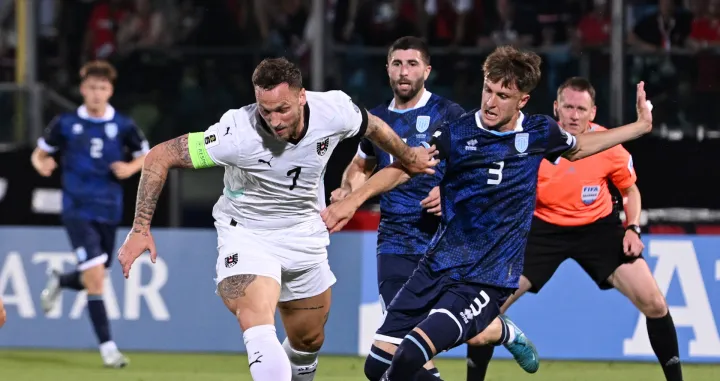 Soccer Football - World Cup - European Qualifiers - Group H - San Marino v Austria - San Marino Stadium, Serravalle, San Marino - June 10, 2025 Austria's Marko Arnautovic in action with San Marino's Tommaso Benvenuti REUTERS/Jennifer Lorenzini
