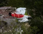 A tail of an Air India Boeing 787 Dreamliner plane that crashed is seen stuck on a building after the incident in Ahmedabad, India, June 12, 2025. REUTERS/Amit Dave/Amit Dave