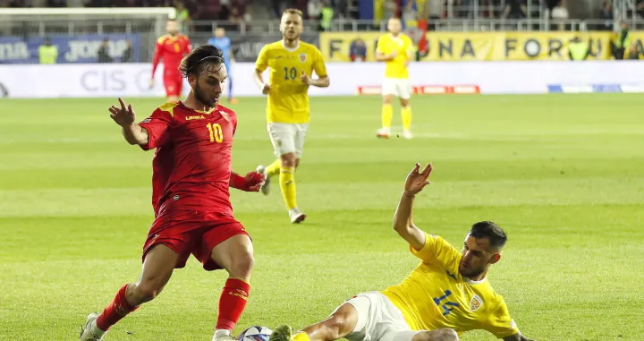 epa10013353 Marius Marin (R) of Romania in action against Ilija Vukotic (L) of Montenegro during the UEFA Nations League soccer match between Romania and Montenegro in Bucharest, Romania, 14 June 2022. EPA/ROBERT GHEMENT