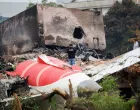 A fire officer stands next to the crashed Air India Boeing 787-8 Dreamliner aircraft, in Ahmedabad, India, June 13, 2025. REUTERS/Adnan Abidi  TPX IMAGES OF THE DAY/Adnan Abidi