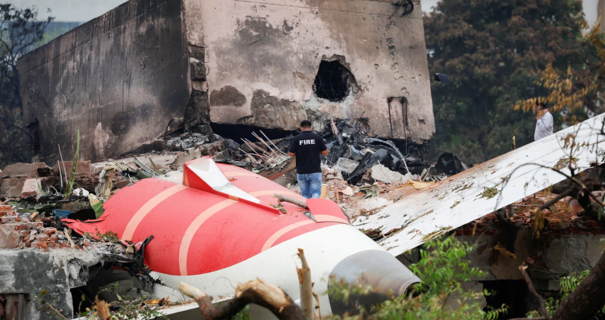 A fire officer stands next to the crashed Air India Boeing 787-8 Dreamliner aircraft, in Ahmedabad, India, June 13, 2025. REUTERS/Adnan Abidi TPX IMAGES OF THE DAY/Adnan Abidi