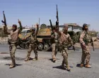 FILE PHOTO: Syrian security forces walk together along a street, after clashes between Syrian government troops and local Druze fighters resumed in the southern Druze city of Sweida early on Wednesday, collapsing a ceasefire announced just hours earlier that aimed to put an end to days of deadly sectarian bloodshed, in Sweida, Syria July 16, 2025. REUTERS/Karam al-Masri/File Photo/Karam Al-masri
