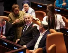 Israeli Prime Minister Benjamin Netanyahu speaks with National Security Minister Itamar Ben-Gvir, at the plenum in the Knesset, Israel's parliament, ahead of a vote over possible expulsion of Ayman Odeh from parliament, in Jerusalem, July 14, 2025. REUTERS/Ronen Zvulun/Ronen Zvulun