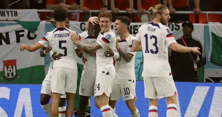 epa10318923 Timothy Weah (3L) of the USA celebrates with teammates after scoring the opening goal during the FIFA World Cup 2022 group B soccer match between the USA and Wales at Ahmad bin Ali Stadium in Doha, Qatar, 21 November 2022. EPA/Ronald Wittek