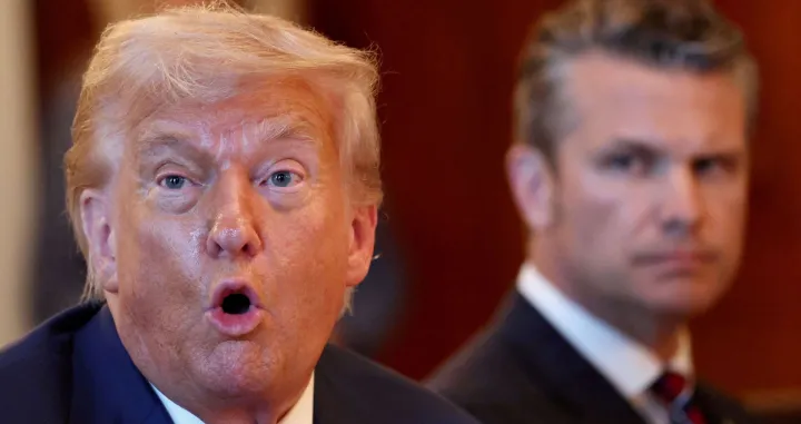 FILE PHOTO: U.S. Defense Secretary Pete Hegseth looks at U.S. President Donald Trump as he speaks during a bilateral dinner with Israeli Prime Minister Benjamin Netanyahu (not pictured), at the White House in Washington, D.C., U.S., July 7, 2025. REUTERS/Kevin Lamarque/File Photo/Reuters/kevin Lamarque/file Photo
